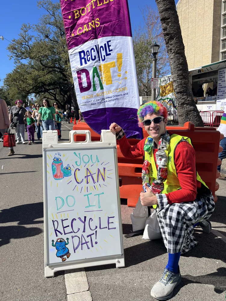 RecycleDAT flag banner and volunteer at parade station