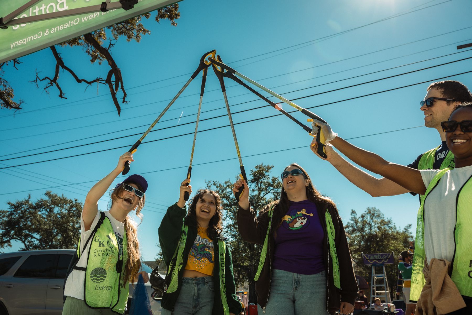 Volunteer crew with pickers held aloft